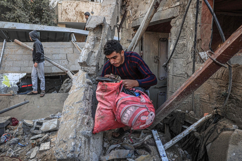People search for belongings following an Israeli strike in Rafah in the southern Gaza Strip. — AFP
