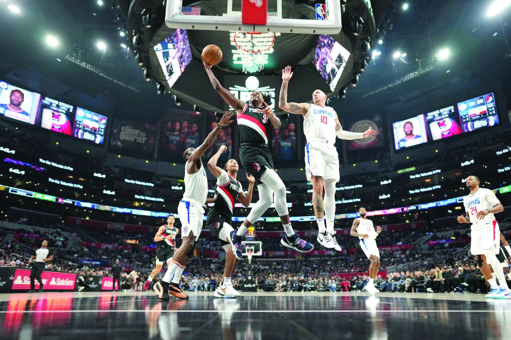 Dec 11, 2023; Los Angeles, California, USA; Portland Trail Blazers forward Jabari Walker (34) shoots the ball against LA Clippers centre Daniel Theis (10) in the second half at Crypto.com Arena. Mandatory Credit: Kirby Lee-USA TODAY Sports