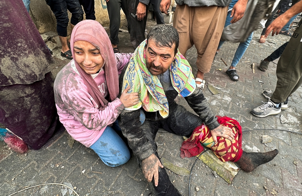People react following an Israeli air strike on Palestinian houses