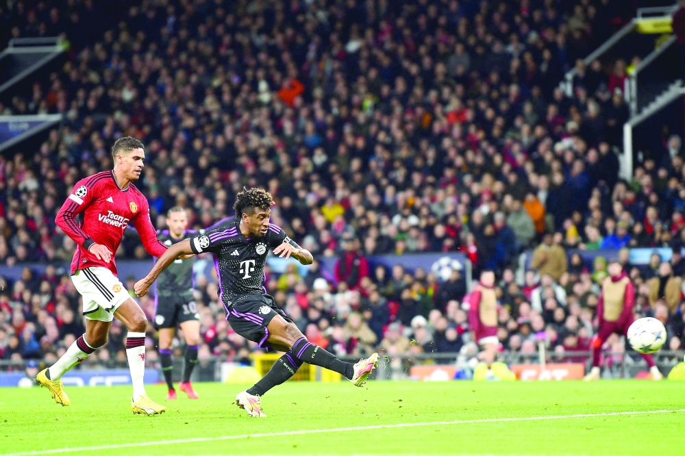 Bayern Munich's French forward #11 Kingsley Coman scores the opening goal during the UEFA Champions League group A football match between Manchester United and FC Bayern Munich at Old Trafford stadium in Manchester, north west England, on December 12, 2023. (Photo by PETER POWELL / AFP)

