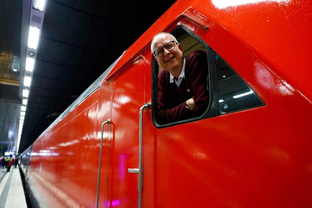 The train conductor reacts during the launch of the Berlin-Paris night 'train night-jet' at the main station in Berlin, on Wednesday. - AFP
