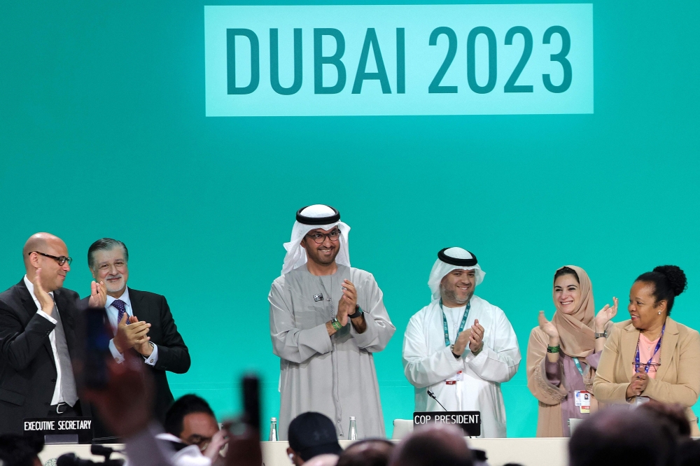 COP28 president Sultan Ahmed Al Jaber (C) applauds among other officials before a plenary session during the United Nations climate summit in Dubai. — AFP 
