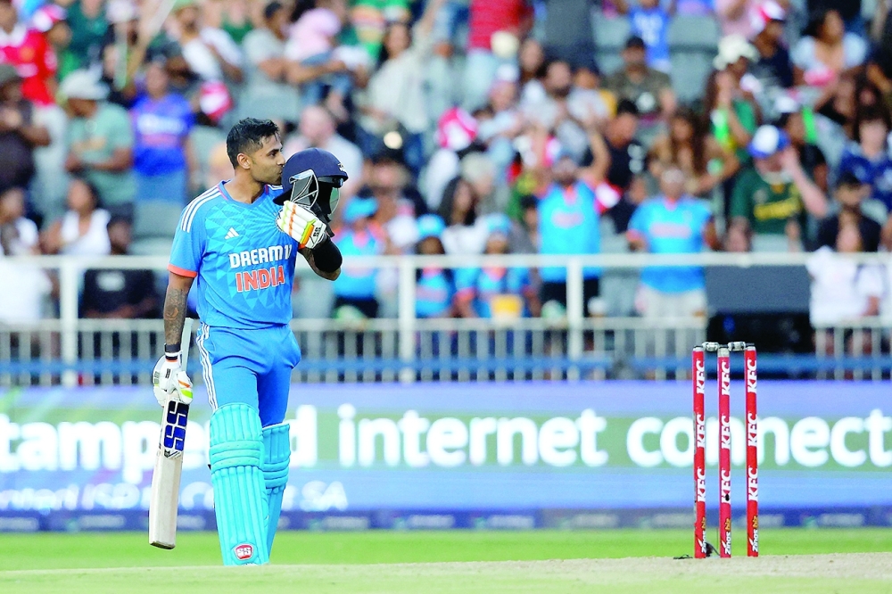 India's Suryakumar Yadav celebrates after scoring a century (100 runs) during the third T20 cricket match between South Africa and India at the Wanderers Stadium in Johannesburg on December 14, 2023. (Photo by PHILL MAGAKOE / AFP)

