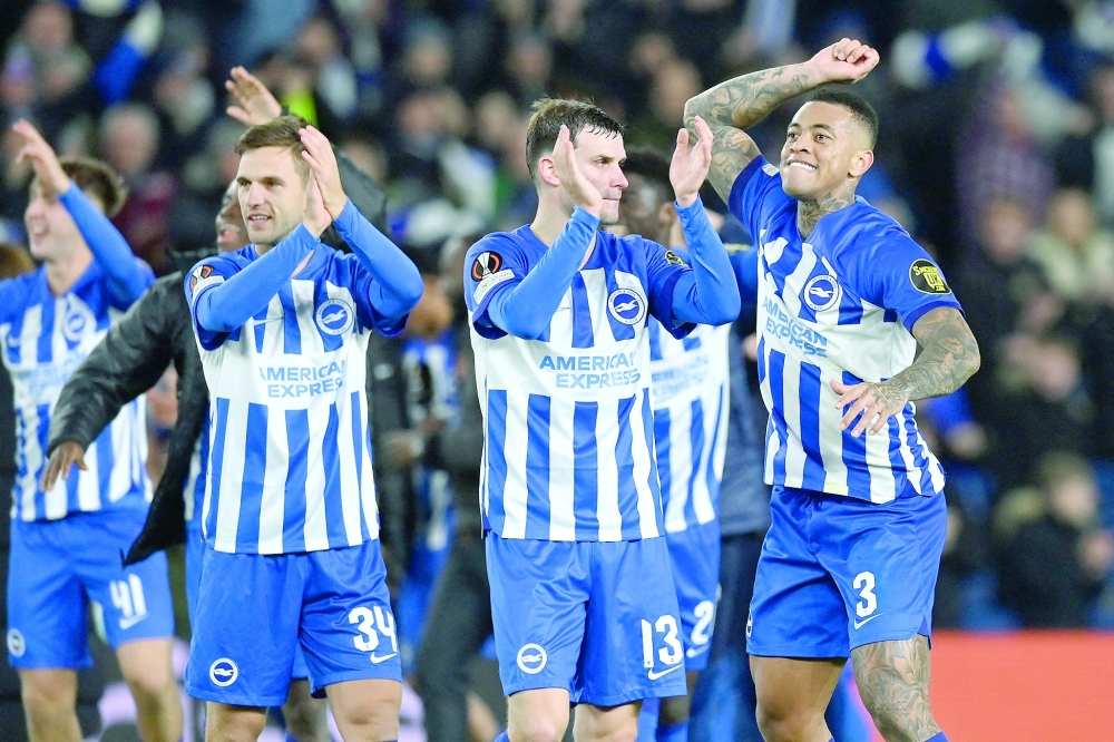 Brighton's players celebrate on the pitch after the UEFA Europa League Group B football match between Brighton and Hove Albion and Marseille at the American Express Community Stadium in Brighton, southern England on December 14, 2023. Brighton won the game 1-0 and top the Group. (Photo by Glyn KIRK / AFP)