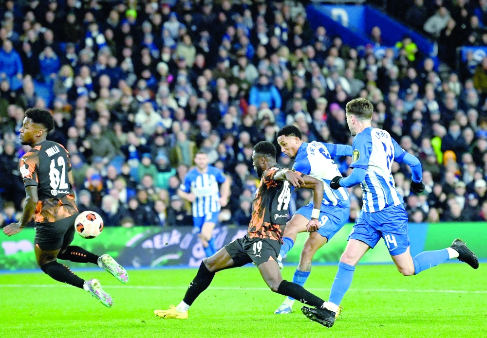 Brighton's Brazilian striker #09 Joao Pedro (2R) shoots to score the opening goal of the UEFA Europa League Group B football match between Brighton and Hove Albion and Marseille at the American Express Community Stadium in Brighton, southern England on December 14, 2023. (Photo by Glyn KIRK / AFP)