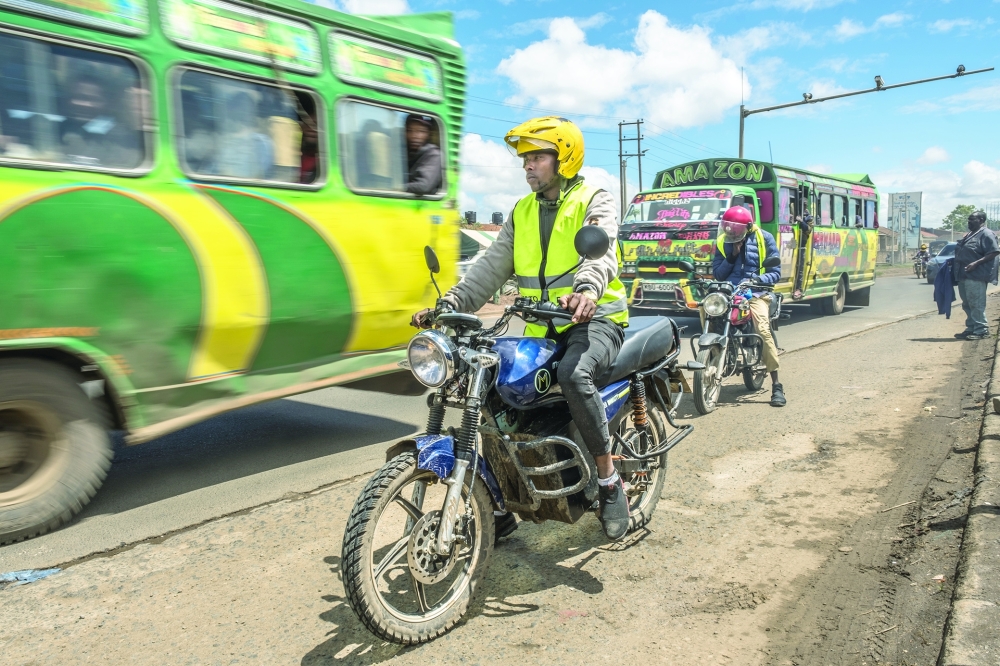 Brian Omogi rides a Mazi Mobility e-motorbike in Nairobi, Kenya.