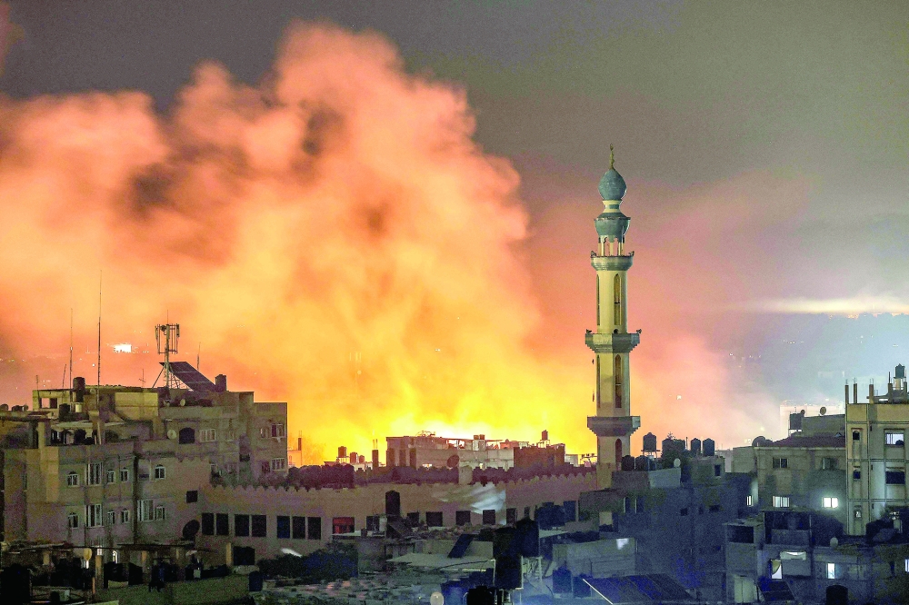 Fire and smoke erupt after Israeli bombardment in Rafah in the southern Gaza Strip. — AFP 