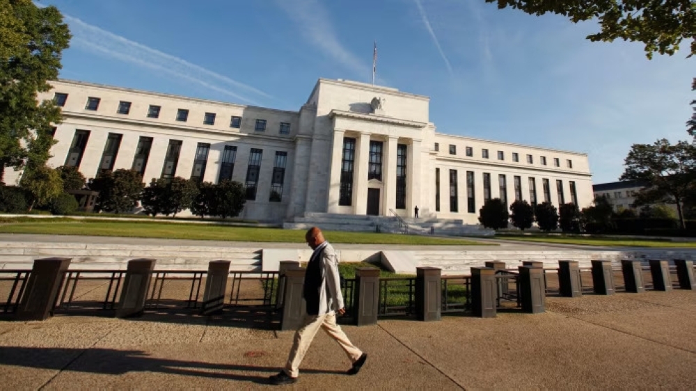 A man walks past the US Federal Reserve building in Washington. — Reuters