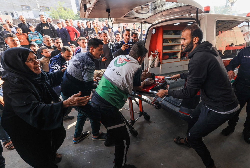 A woman reacts as medics transport a Palestinian man injured in Israeli bombardment, at Nasser hospital in Khan Yunis. — AFP 