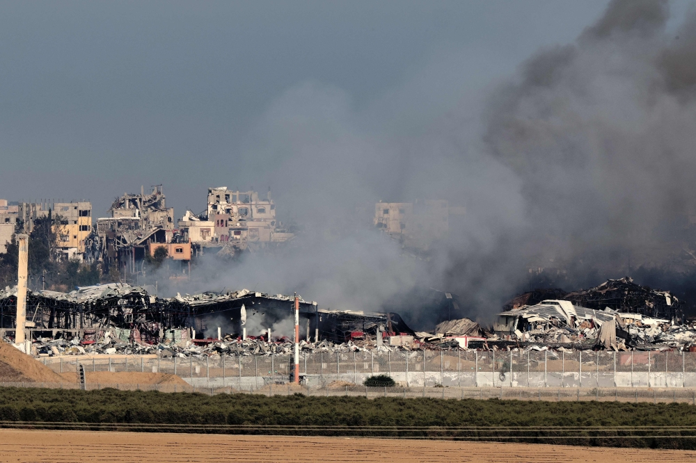 A picture shows destruction and smoke in the north of the Gaza Strip, resulting from weeks of Israeli bombardment. — AFP 