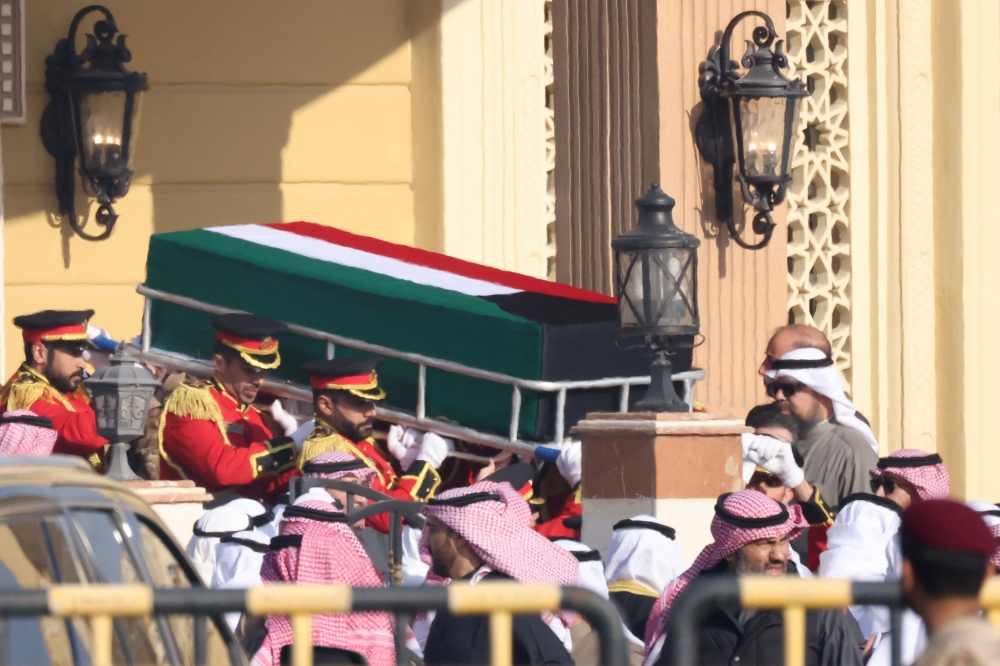 The coffin of Kuwait's late Emir Shaikh Nawaf Al Ahmad al Sabah is carried out of the Bilal bin Rabah Mosque in Kuwait City ahead of burial during his funeral on Sunday. - AFP