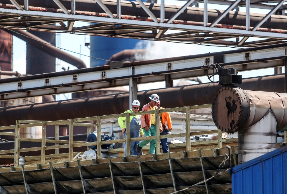 Steel workers are seen at US Steel Granite City Works in Granite City, Illinois. — Reuters