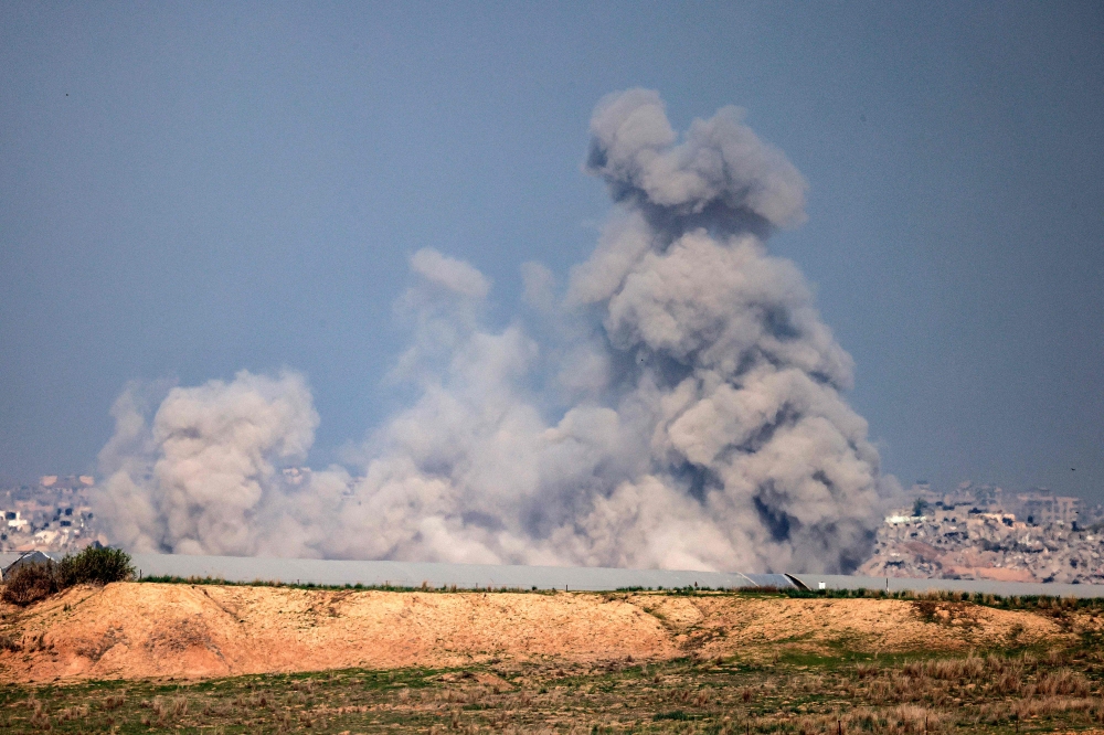 A smoke plume rises during Israeli bombardment at a position along the border with the northern Gaza Strip. — AFP 