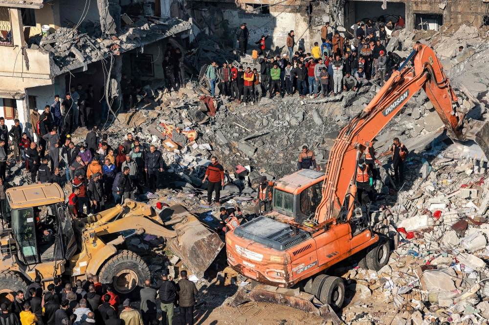 Excavators dig through the rubble of a building destroyed by Israeli bombardment in Rafah in the southern Gaza Strip. — AFP 