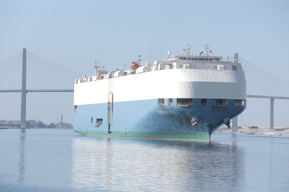 A container ship is seen near Suez Canal Bridge 