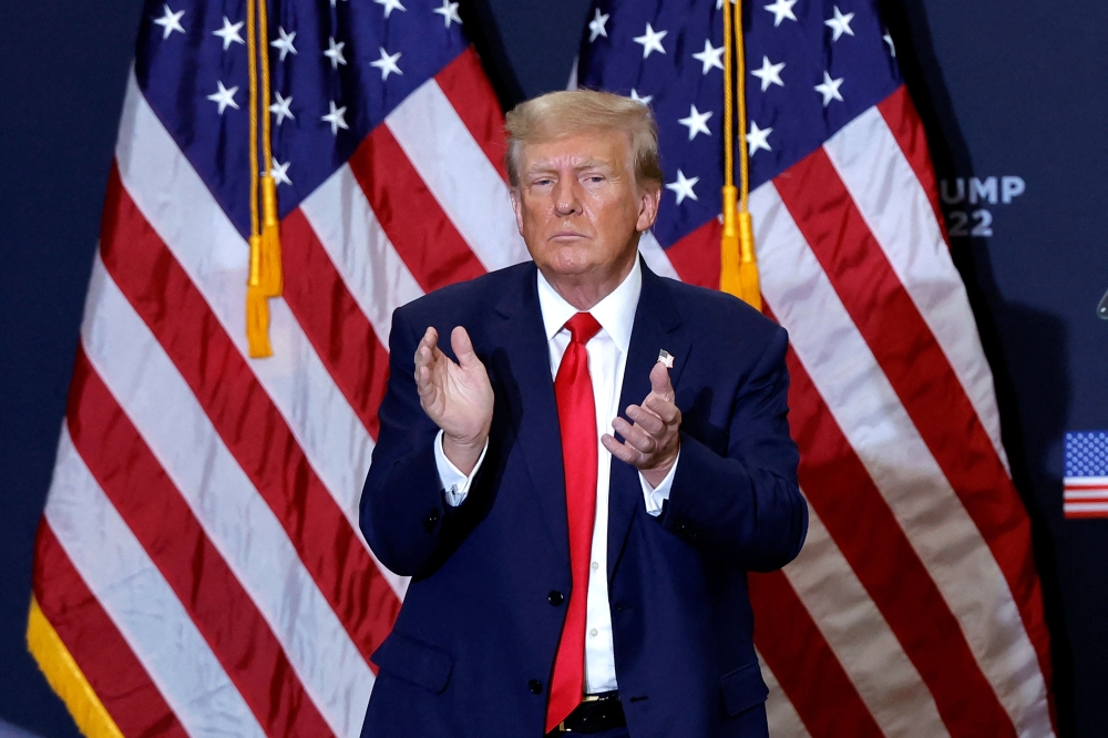 Former US President and 2024 presidential hopeful Donald Trump applauds at the end of a campaign event in Waterloo, Iowa. - AFP 