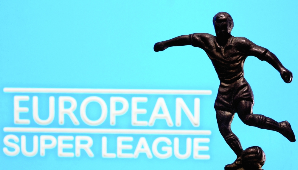 FILE PHOTO: A metal figure of a football player with a ball is seen in front of the words "European Super League" in this illustration taken on April 20, 2021. REUTERS/Dado Ruvic/Illustration/File Photo