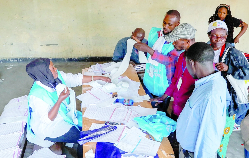 Independent National Electoral Commission officials and polling agents tally votes at the Mavuno polling centre after the end of voting amid the parliamentary and presidential election in Goma, North Kivu province, the Democratic Republic of Congo. - Reuters