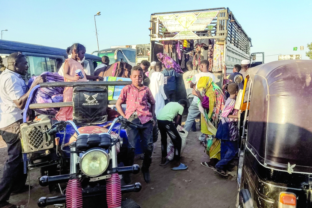 People displaced by the conflict in Sudan get in their transporation as they flee Wad Madani, the capital of Al Jazirah state. - AFP