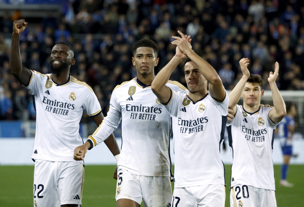 Real Madrid's Jude Bellingham, Lucas Vazquez and Antonio Rudiger celebrate after the match REUTERS