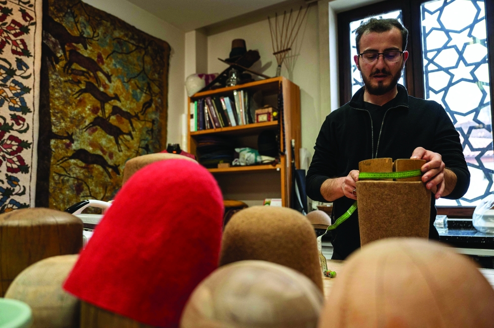 Yunus Girgic works in a workshop with moulds used to make the symbolic hat 'Sikke', worn by whirling dervishes in Konya 
