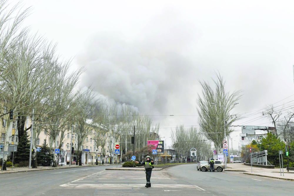 Smoke rises over buildings in an aftermath of recent shelling in Donetsk, Ukraine. — AFP