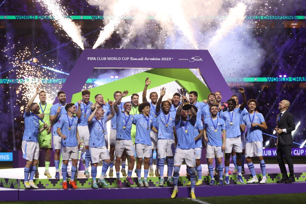 Manchester City's English defender #02 Kyle Walker lifts the trophy after the FIFA Club World Cup final football match between Brazil's Fluminense and England's Manchester City at the King Abdullah Sports City in Jeddah on December 22, 2023. (Photo by AFP)
