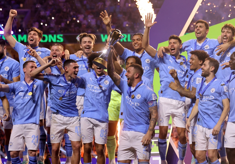 Soccer Football - Club World Cup - Final - Manchester City v Fluminense - King Abdullah Sports City, Jeddah, Saudi Arabia - December 22, 2023 Manchester City's Kyle Walker lifts the trophy alongside teammates after winning the Club World Cup final REUTERS/Amr Abdallah Dalsh
