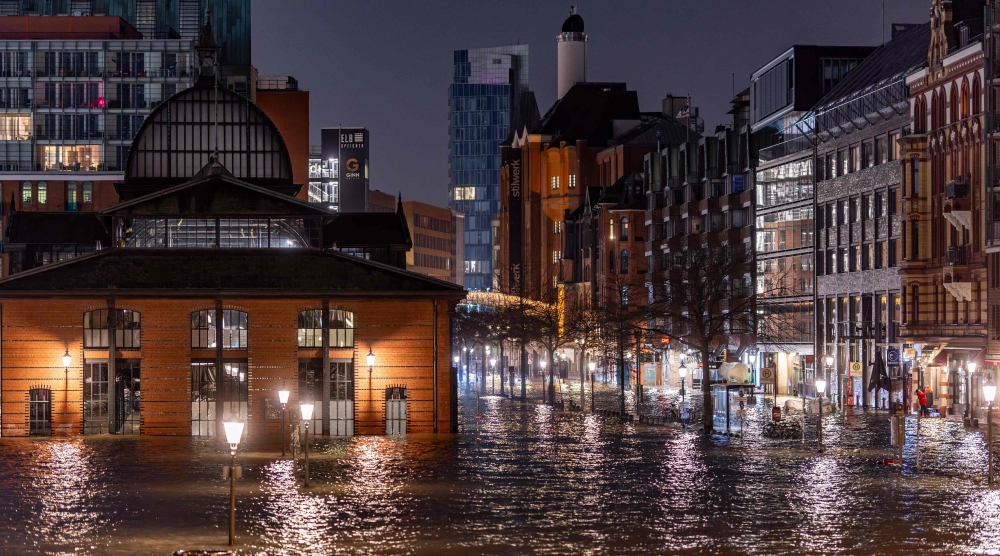 The fishmarket and surrounding streets on the Hamburg waterfront are flooded due to a storm surge, in northern Germany, on December 22. — AFP 