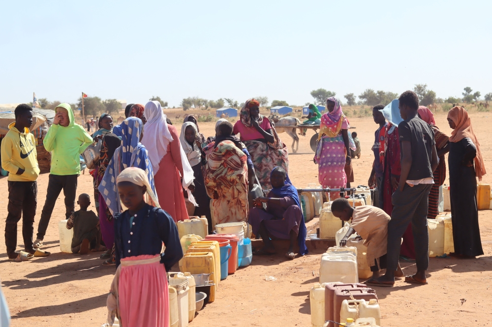 Refugees fleeing the conflict in Sudan queue with their jerrycans to queue to collect drinking water from the Doctors Without Borders (MSF) distribution point at the Ourang refugee camp in Adr. — AFP file photo