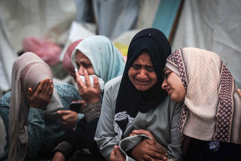 Palestinians mourn their relatives, killed in an overnight Israeli strike on the Al-Maghazi refugee camp, during a mass funeral at the Al-Aqsa hospital in Deir Al-Balah, in the southern Gaza Strip. — AFP 