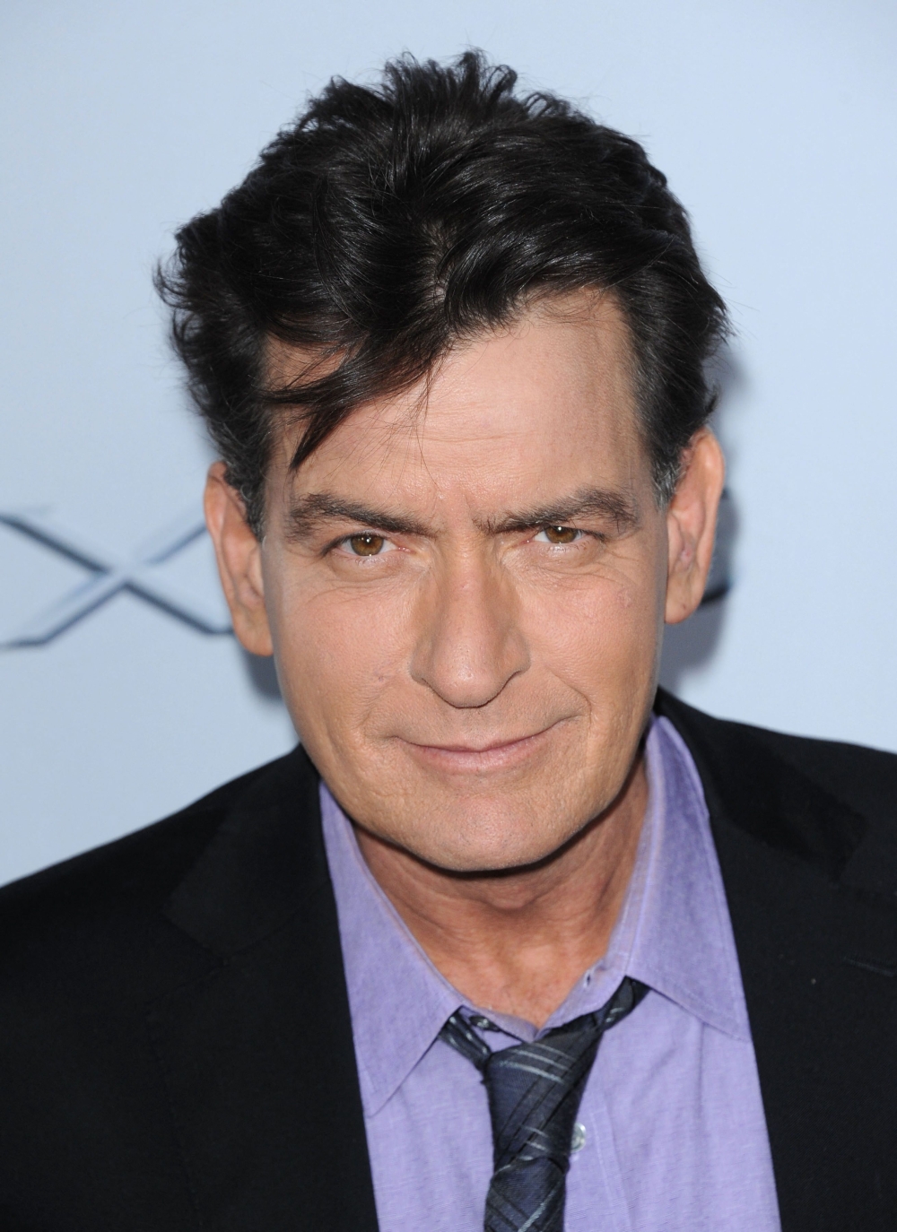 (FILES) US actor Charlie Sheen attends the premiere of 'Scary Movie 5' at the Arclight theatre in Hollywood, California, on April 11, 2013. Sheen was attacked in his luxury Malibu home, police said on December 22, 203, with the suspect arrested and  charged with assault and burglary. (Photo by Chris Delmas / AFP)

