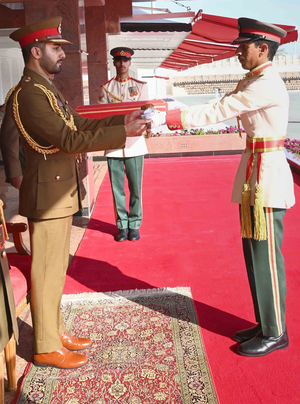 HH Sayyid Theyazin hands over the sword of honour to officer cadet Mustafa Hamad al Samri. 