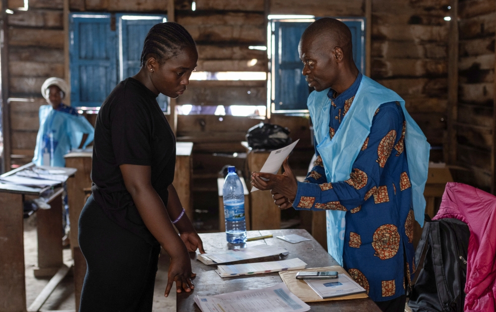 An independent National Electoral Commission (CENI) agent processes a voter at the Nyabushongo Institute polling centre on the second day of the Presidential election in Goma, North Kivu province of the Democratic Republic of Congo December 21, 2023. 
