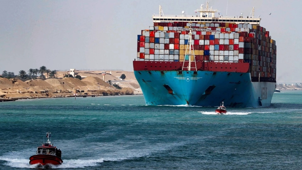 A shipping container passes through the Suez Canal in Suez, Egypt. — Reuters