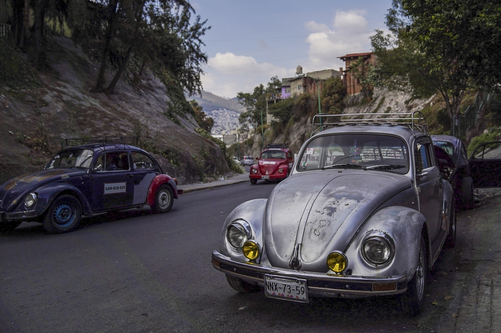Volkswagen Beetles on a road in the Cuautepec neighbourhood of Mexico City.
