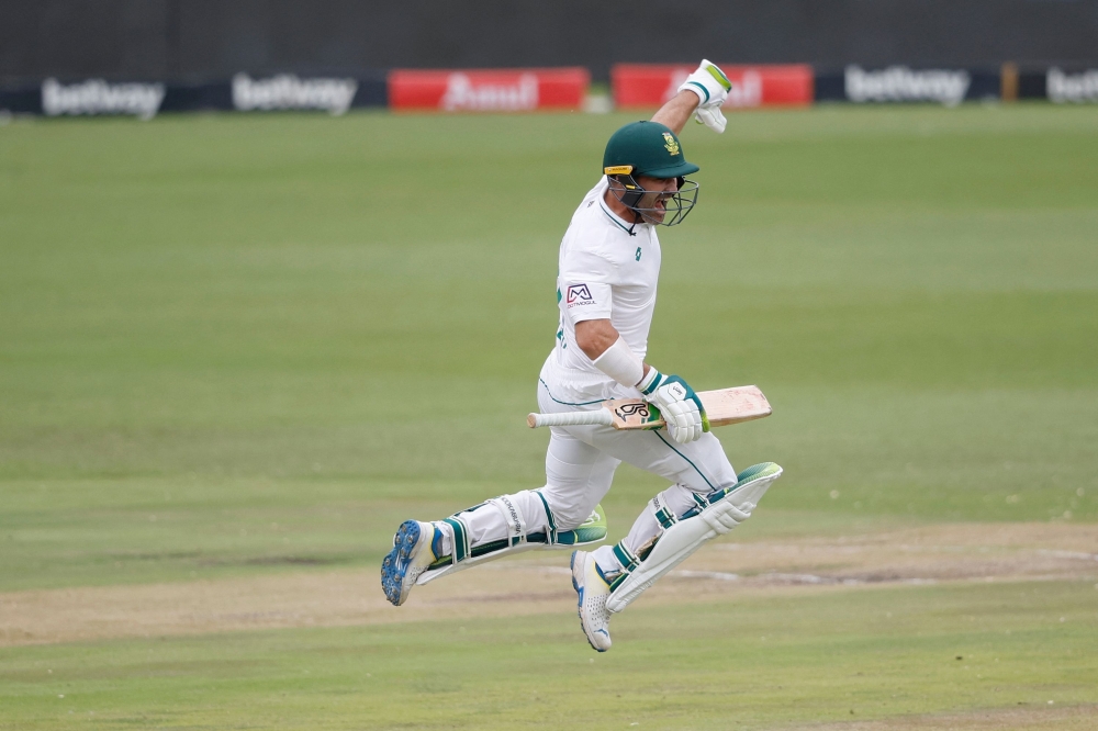 TOPSHOT - South Africa's Dean Elgar celebrates after scoring a century (100 runs) during the second day of the first cricket Test match between South Africa and India at SuperSport Park in Centurion on December 27, 2023. (Photo by PHILL MAGAKOE / AFP)
