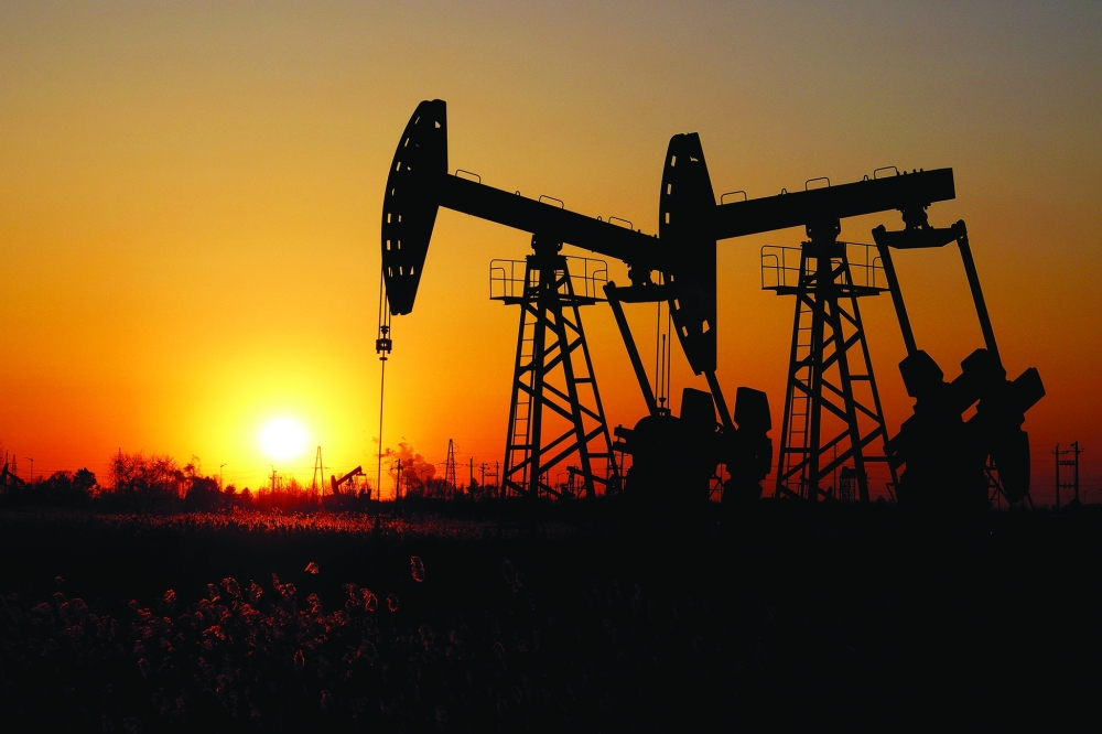 Pumpjacks are seen against the setting sun at the Daqing oil field in Heilongjiang