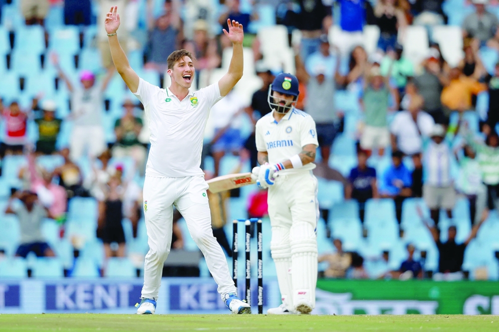 South Africa's Nandre Burger (L) unsuccessfully appeals for the dismissal of India's Virat Kohli (R) during the third day of the first cricket Test match between South Africa and India at SuperSport Park in Centurion on December 28, 2023. (Photo by PHILL MAGAKOE / AFP)


