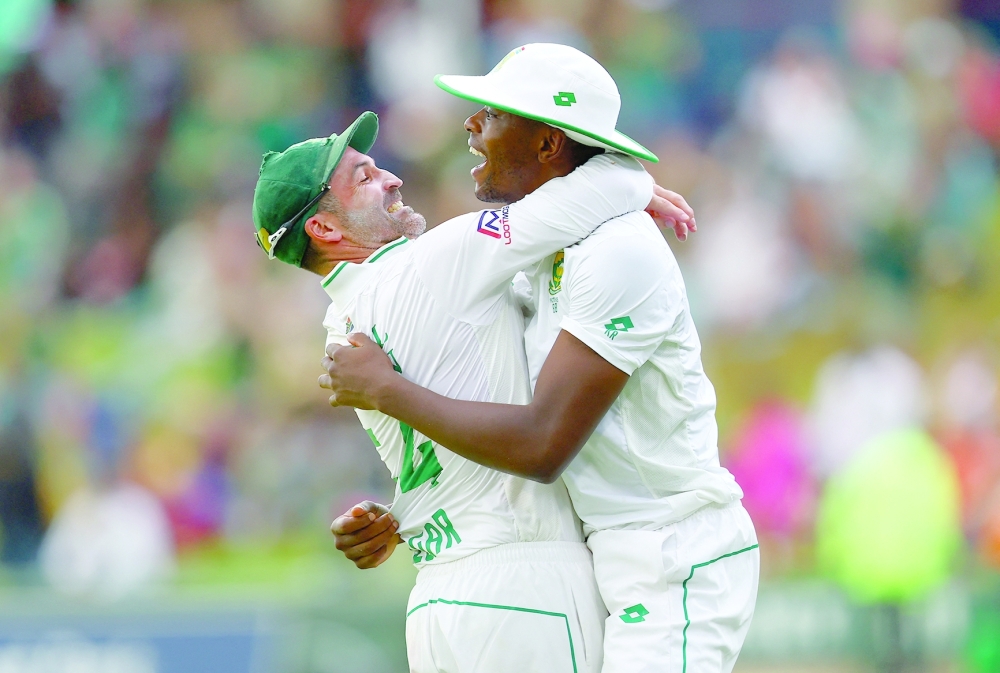 First Test - South Africa v India - SuperSport Park Cricket Stadium, Centurion, South Africa - December 28, 2023 South Africa's Kagiso Rabada celebrates after catching out India's Virat Kohli with Dean Elgar to win the match REUTERS/Esa Alexander