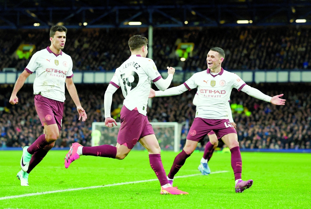 Soccer Football - Premier League - Everton v Manchester City - Goodison Park, Liverpool, Britain - December 27, 2023 Manchester City's Julian Alvarez celebrates scoring their second goal with Rodri and Phil Foden REUTERS