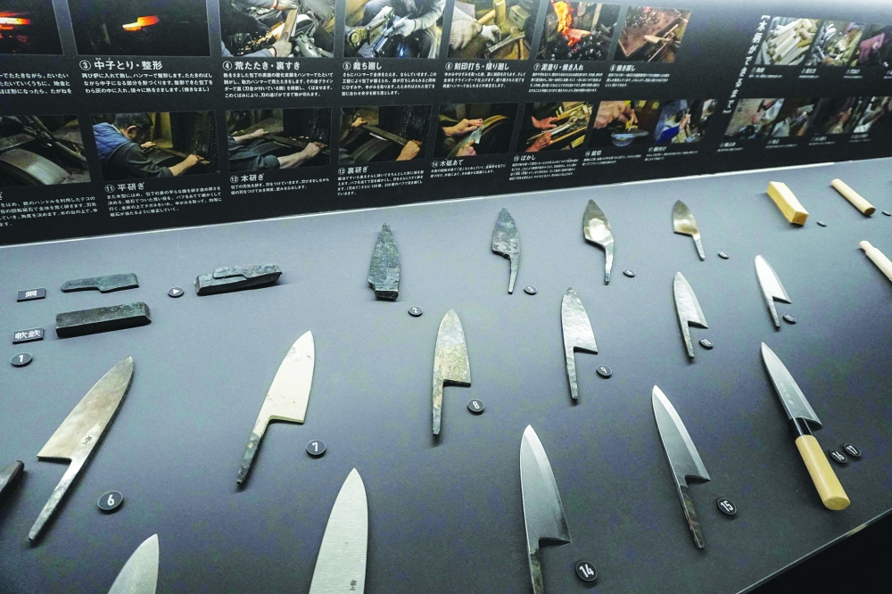 This photo taken on November 14, 2023 shows knives on display at the Sakai Traditional Crafts Museum in the city of Sakai, Osaka prefecture. Knife makers can spend an entire day perfecting a single piece. The metal is heated in until malleable and then hammered -- a process repeated several times -- before being shaped, quenched in oil or water and left to cool. 