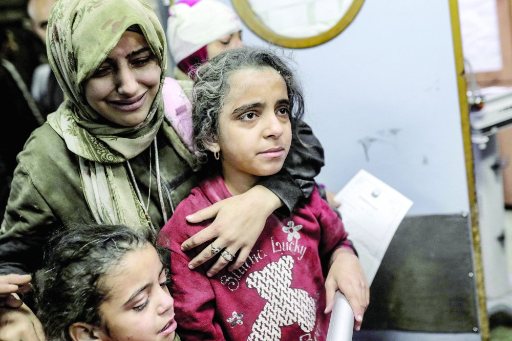 Palestinians, wounded in an Israeli strike, receive treatment at the Nasser hospital in Khan Yunis on the southern Gaza Strip. — AFP 