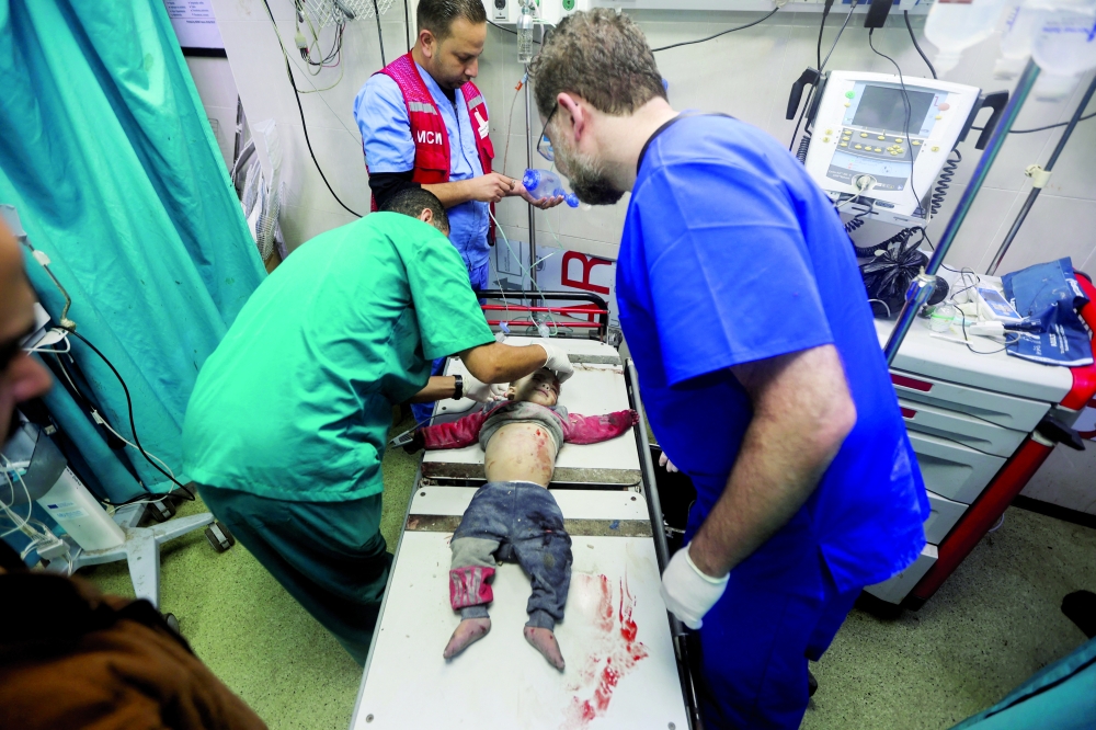 A child wounded in an Israeli strike is assisted at a hospital in Khan Younis. — Reuters 