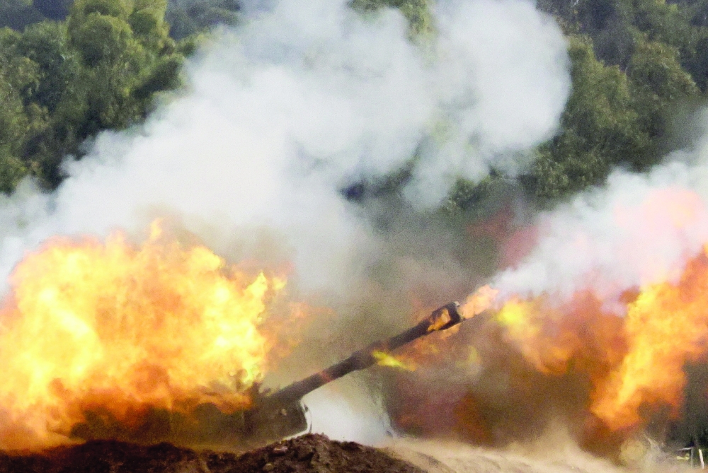 An Israeli artillery unit fires near Gaza border. — Reuters 