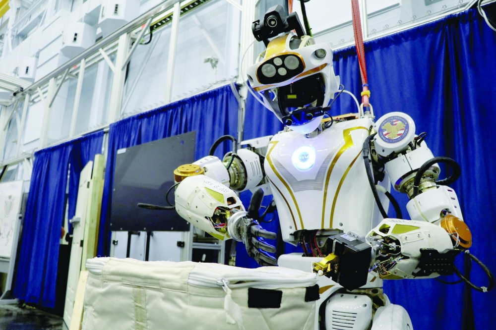 Nasa's humanoid robot Valkyrie opens a bag at the Johnson Space Center in Houston. - Reuters