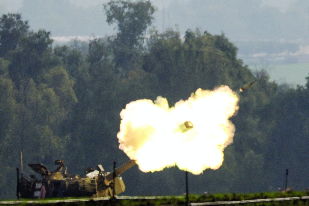 An Israeli artillery unit fires, amid the ongoing conflict between Israel and Hamas, near the Israel-Gaza border, in southern Israel. - Reuters