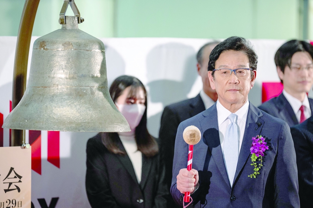 Former manager of Japan's national baseball team Hideki Kuriyama hits the bell during a ceremony to mark the close of the end-of-year trading session at the Tokyo Stock Exchange in Tokyo. - AFP

