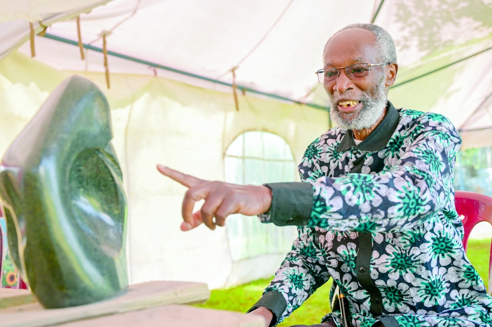Kenyan sculptor Elkana Ong'esa shows one of his sculptures while mentoring a workshop on stone carving in Tabaka near Kisii. - AFP 