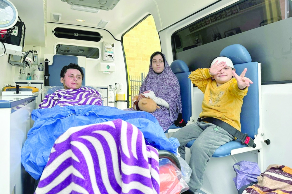 A wounded Palestinian girl reacts as she arrives with others at the Rafah border crossing in Egypt after being evacuated from the Gaza Strip. - AFP
